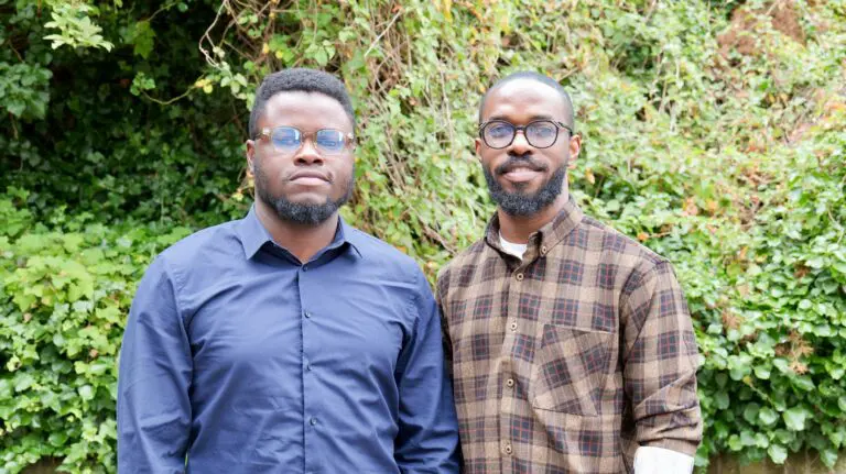 Co-founders of Stitchbloc in front of green foliage