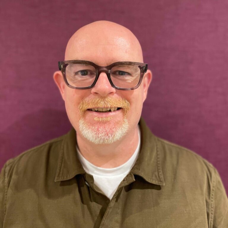 Barry McDonald headshot on maroon background